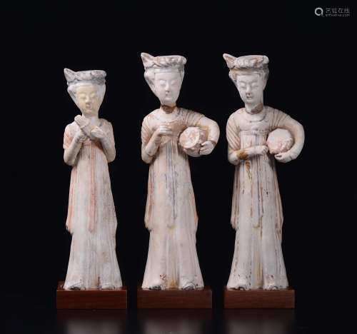 Three painted pottery figures of musicians, China, Tang Dynasty  ...