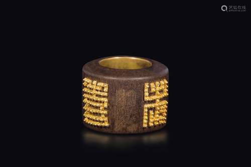 A wooden archer ring with golden details, China, Qing Dynasty,  ...