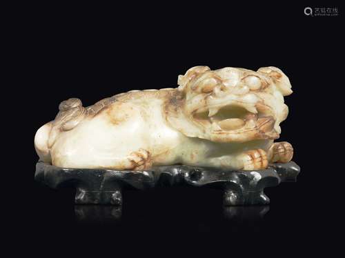 A white and russet jade figure of a lying dog, China, Qing  ...