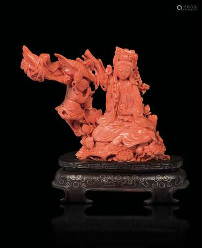 A carved coral group with Guanyin and praying child, China,  ...