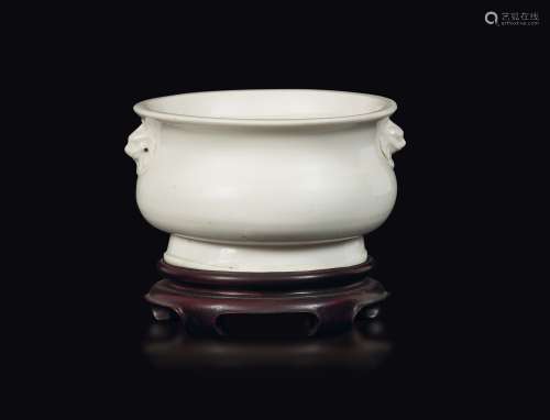 A Blanc de Chine Dehua porcelain censer with mask handles,  ...