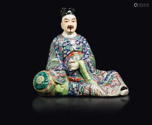 A polychrome enamelled porcelain figure of a seated dignitary  ...