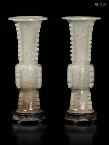 A pair of white and russet jade archaic shape vases, China,  ...