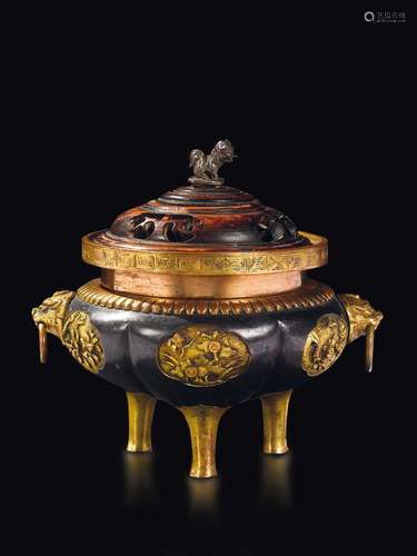 A burnished and gilt bronze tripod censer with fretworked  ...