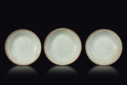 Three glazed stoneware small dishes with decoration in relief,  ...
