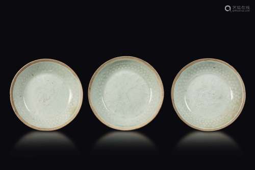 Three glazed stoneware small dishes with decoration in relief,  ...