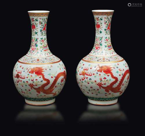 A pair of polychrome enamelled porcelain bottle vases with  ...