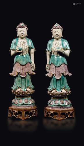 A pair of glazed bisquit figures of standing Buddha with peaches,  ...