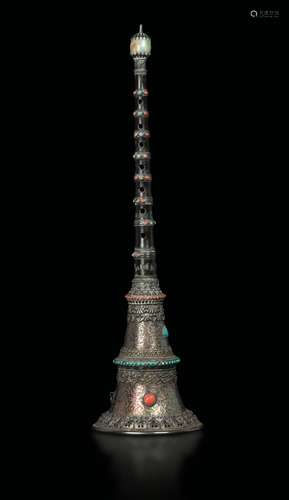 A silver trumpet with coral, turquoise and jade inlays, Tibet,  ...