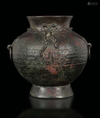 A bronze vase with ring handles and a geometric archaic style  ...