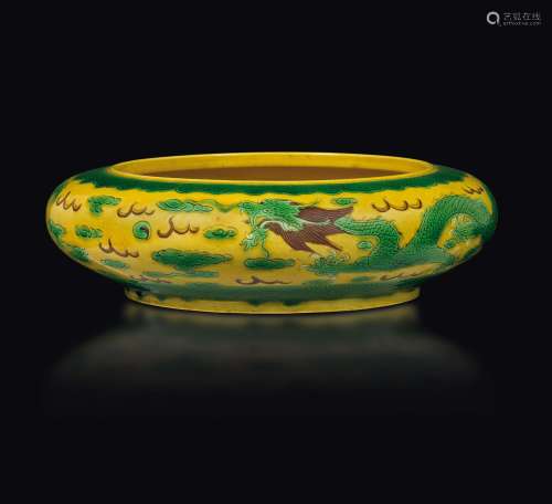 A Sancai porcelain bowl with dragons between clouds, China,  ...