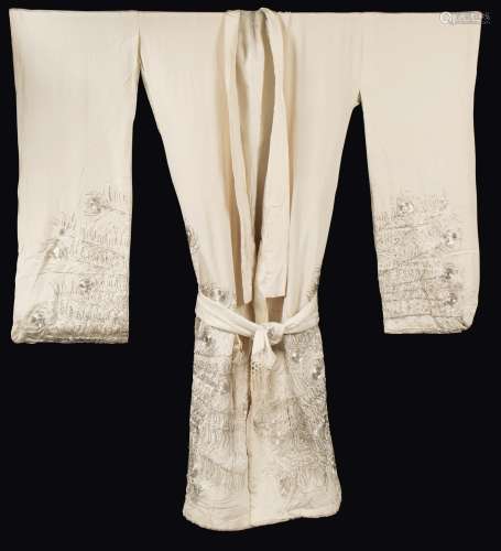 A white-ground silk dress embroidered with peacock's feathers,  ...