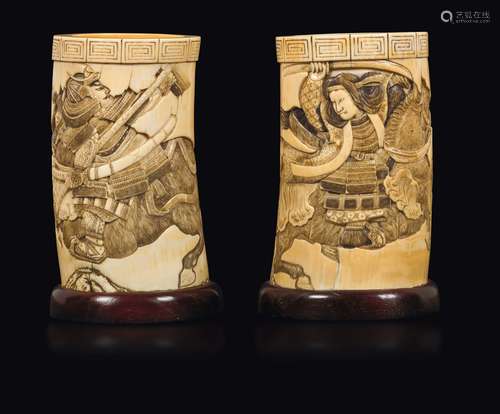 A pair of carved ivory brushpots with figure of samurai and  ...