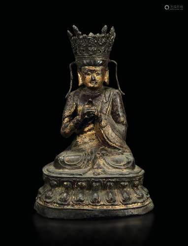 A gilt bronze figure of deity seated on a double lotus flower,  ...