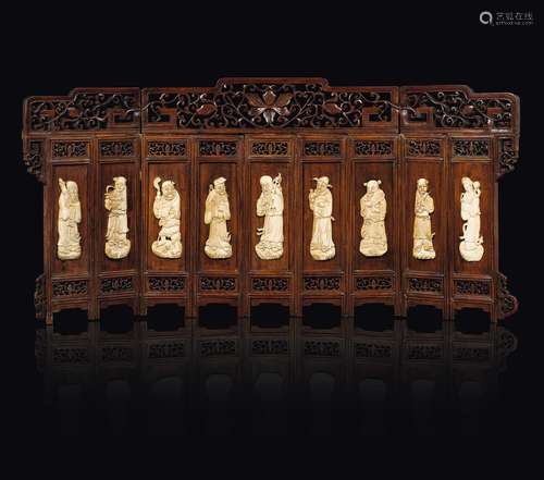 A small wooden screen with carved ivory figures of wise men,  ...