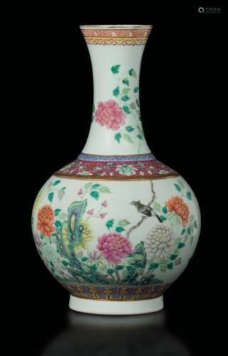 A polychrome enamelled porcelain bottle vase with flowers  ...