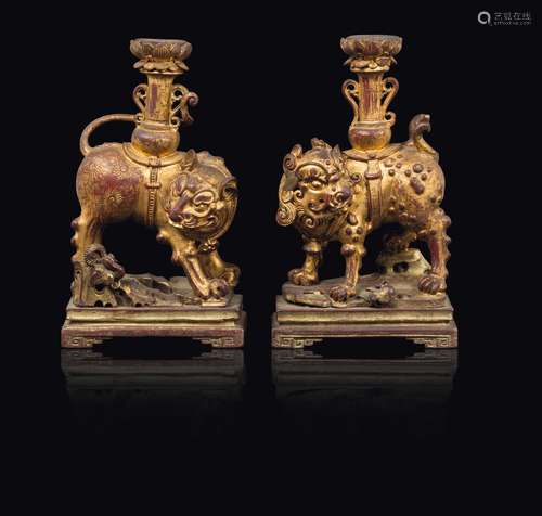 A pair of lacquered wood Pho dog candlesticks, China, Qing  ...