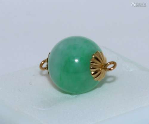 A Jadite Bead Mounted in gold