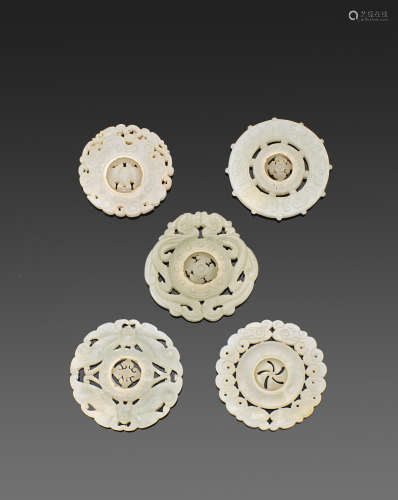 A group of five reticulated jade circular plaques