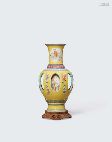 Qianlong mark, Republic period A four-section polychrome enameled porcelain revolving vase and wood support stand