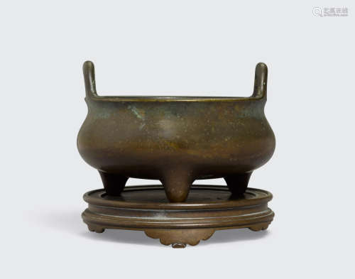 Qing dynasty A bronze bombé censer and a stand