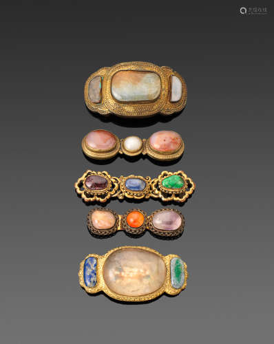 Qing dynasty A GROUP OF FIVE GILT-METAL HARDSTONE AND GLASS MOUNTED BELT BUCKLES