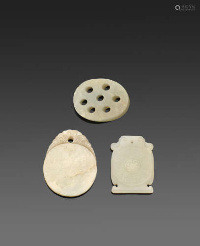A group of three carved jade toggles