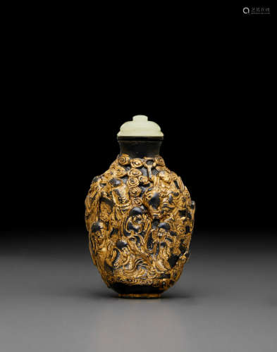 Qianlong mark, late 18th/early 19th century A molded and gilt decorated porcelain snuff bottle simulating gilt bronze