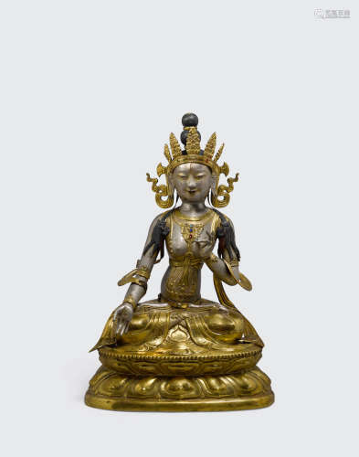 Circa 1900 A polychrome and parcel gilt metal alloy repousse figure of white Tara