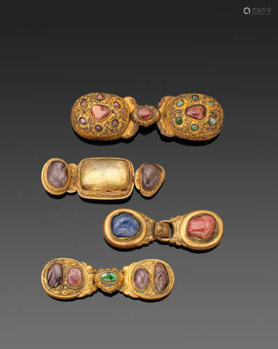 Qing dynasty A GROUP OF FOUR GILT-METAL HARDSTONE MOUNTED BELT BUCKLES