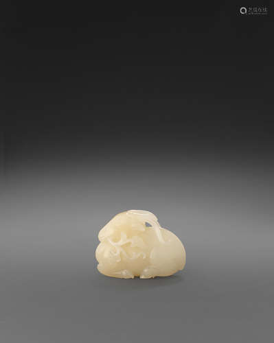 A white jade carving of a recumbent deer