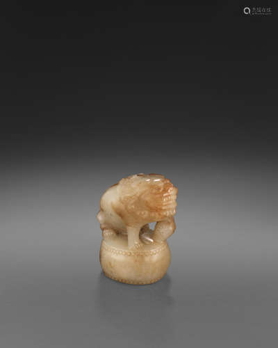 A WHITE AND BROWN JADE 'LION' CARVING