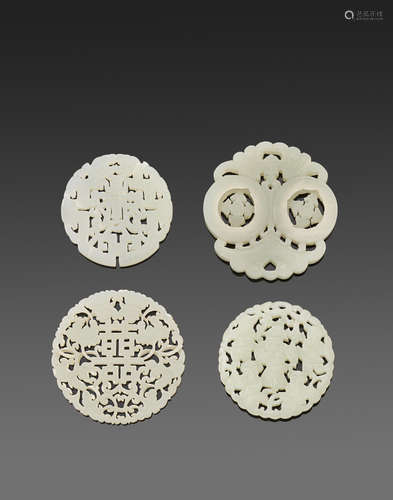 A group of four white jade circular plaques