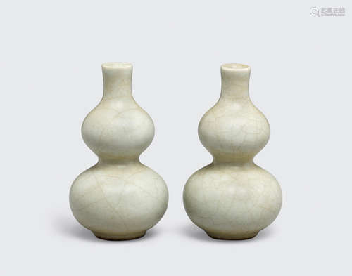 A pair of celadon glazed double gourd miniature vases