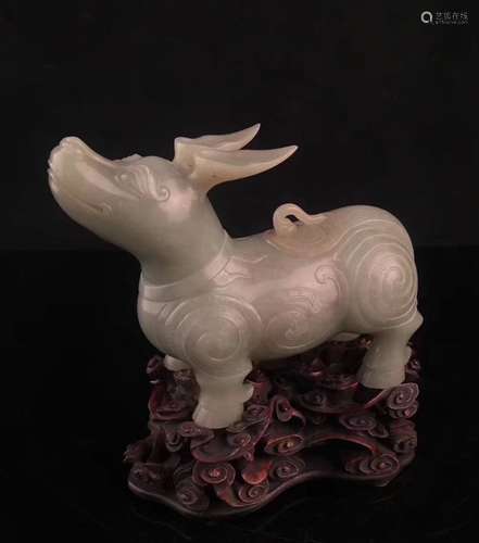 A Carved White Jade Figure With Base