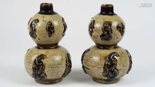 Paire de vases doubles gourdes en grès de Cihzou émaillé crémé et ocre à décor appliqué. <br/>Chine, dynastie Qing, fin XIX ème siècle. <br/>H. 20 cm
