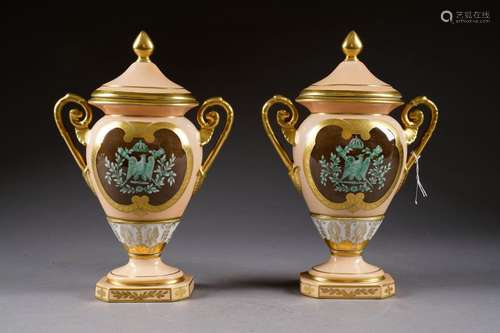 Paire de vases Empire, couverts. A décor d'un aigle impérial couronné, en réserve, sur fond rose orangé, rehaussé de motifs or. Marque. Allemagne. Début du XXe siècle.<br/>Hauteur: 33 cm. Condition: Pas d'accident ni de restauration.