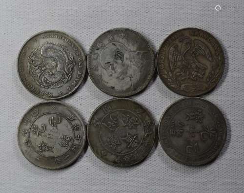 SIX CHINESE DOLLAR COINS