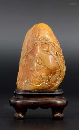A carved Shoushan soapstone with cwooden base