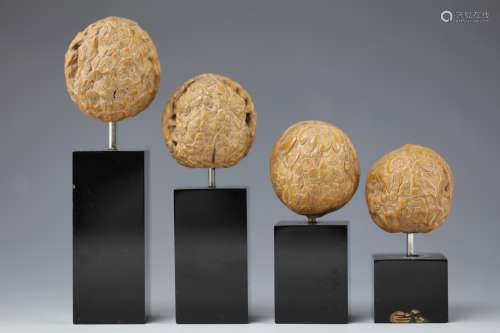 Four carved walnuts from the 19th century