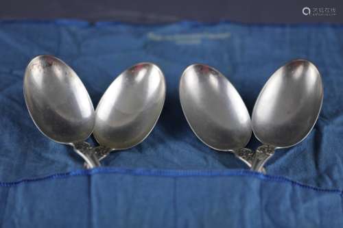 A set of four silver spoons
