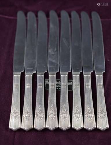 Eight silver cream knives
