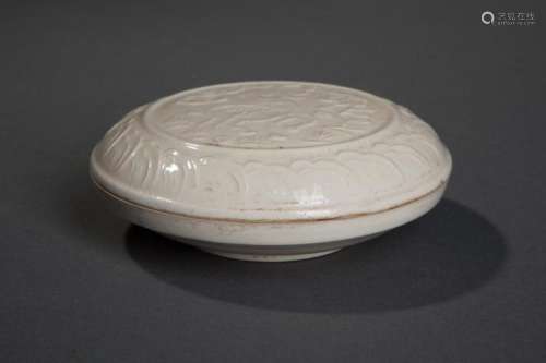 Boîte couverte circulaire de lettré à pate vermillon en porcelaine moulé du décor aux daims et d'une frise lotiforme sous couverte monochrome blanc crémeux.