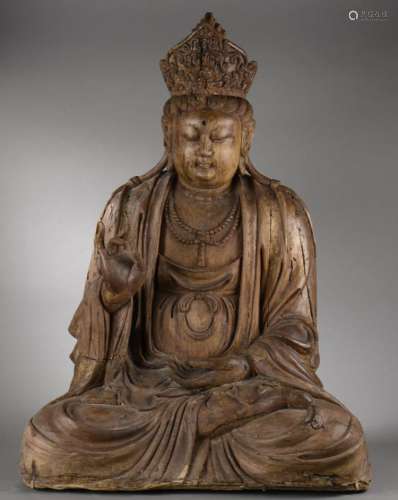 Le Boddhisattva Kwan Yin assis en méditation coiffé d'un diadème incorporant l'image du Buddha Amitabha et vêtu de la robe monastique aux plissés bouillonnants en bois en position de méditation.