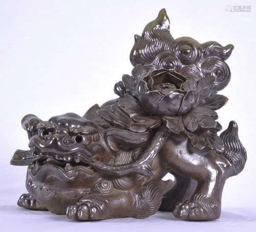 Chinese glazed ceramic fu dog holding a flower in its mouth