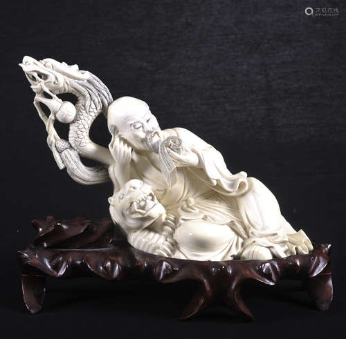 Chinese carving of a man reading, on stand