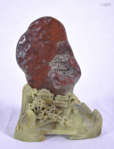 Carved red boulder on carved stand