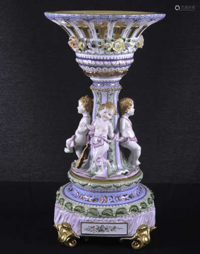 Continental polychrome decorated centerpiece with four cherubs