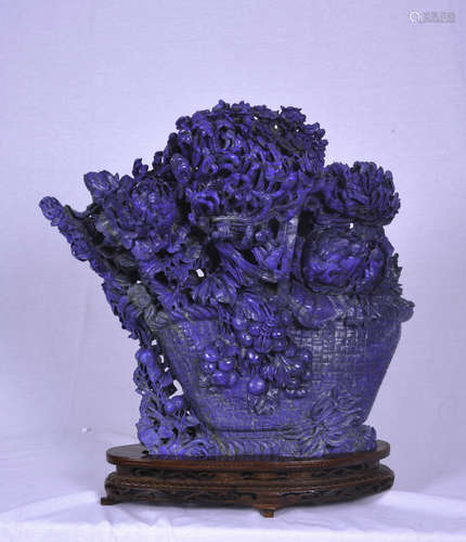 a large carved lapis lazuli sculpture in the form of flowers in a basket