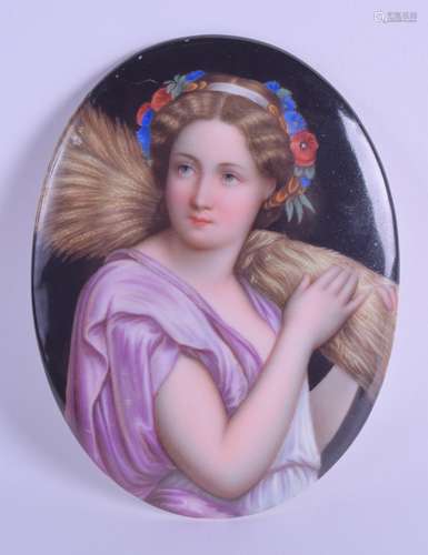 A LATE 19TH CENTURY EUROPEAN PAINTED PORCELAIN PLAQUE depicting a female holding a sheath of corn.